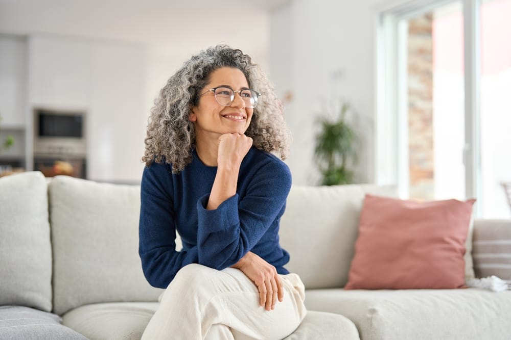 Relaxed woman sitting comfortably on a sofa at home